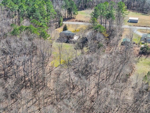 birds eye view of property with a view of trees