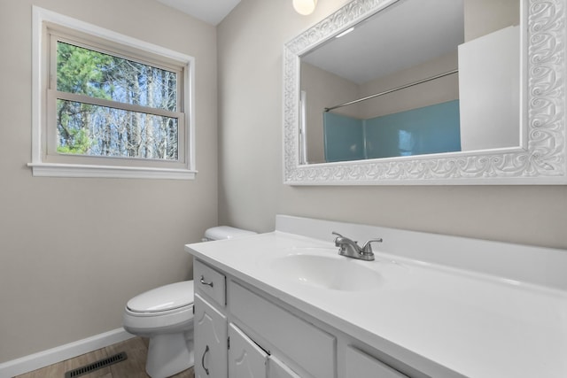 full bath featuring visible vents, toilet, vanity, wood finished floors, and baseboards