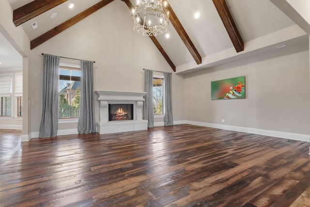 unfurnished living room featuring a healthy amount of sunlight, a lit fireplace, and wood-type flooring