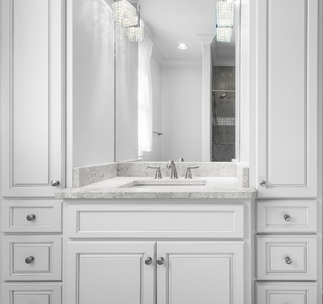 full bathroom featuring vanity, walk in shower, and ornamental molding