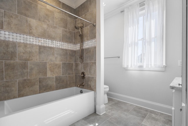 bathroom featuring shower / tub combination, toilet, and baseboards