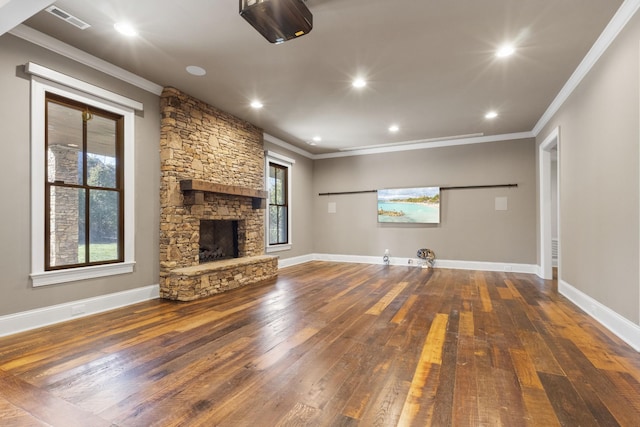 unfurnished living room featuring a fireplace, crown molding, baseboards, and hardwood / wood-style floors