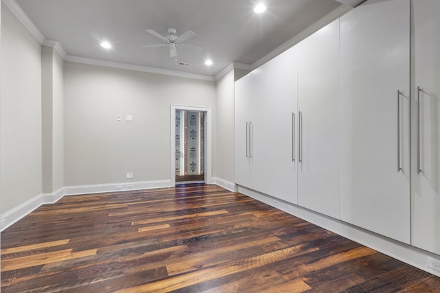 empty room featuring dark wood-style floors, recessed lighting, baseboards, and ornamental molding