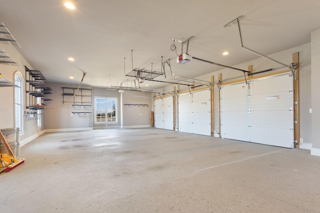 garage featuring a garage door opener and baseboards