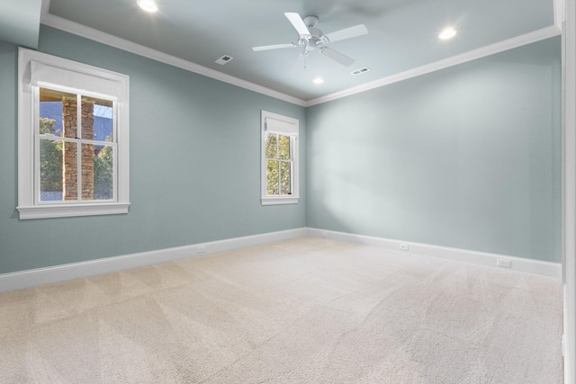 carpeted empty room with visible vents, baseboards, recessed lighting, ceiling fan, and crown molding