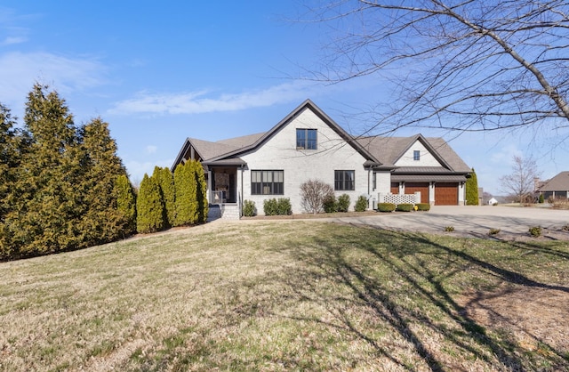 view of front facade featuring a garage, driveway, brick siding, and a front lawn