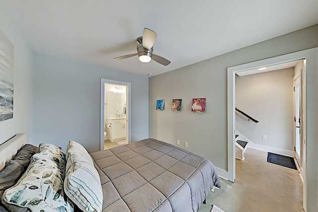 bedroom featuring a ceiling fan, ensuite bath, and baseboards