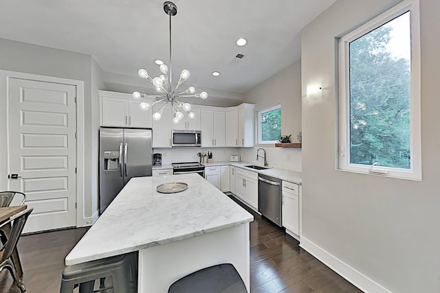 kitchen featuring visible vents, appliances with stainless steel finishes, tasteful backsplash, and a sink