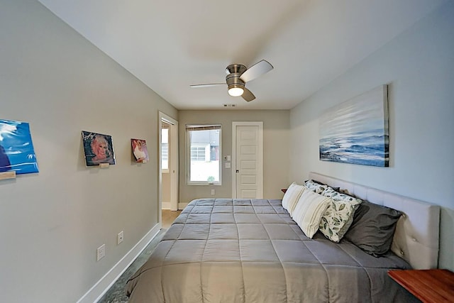 bedroom featuring ceiling fan, visible vents, and baseboards