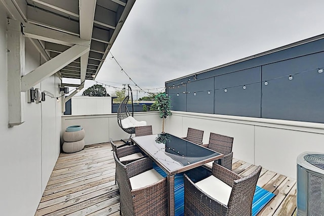 wooden deck with central air condition unit and outdoor dining space