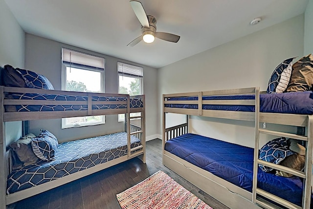 bedroom with ceiling fan, baseboards, and wood finished floors