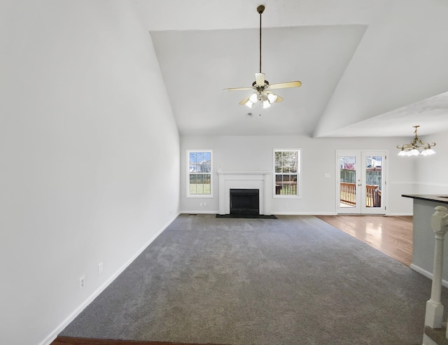 1173 Snoopy Dr, Clarksville, TN 37040 - unfurnished living room featuring high vaulted ceiling, french doors, a fireplace with flush hearth, and baseboards