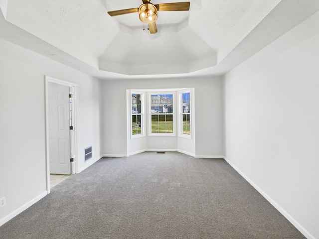 1173 Snoopy Dr, Clarksville, TN 37040 - carpeted spare room with a tray ceiling, a ceiling fan, visible vents, and baseboards