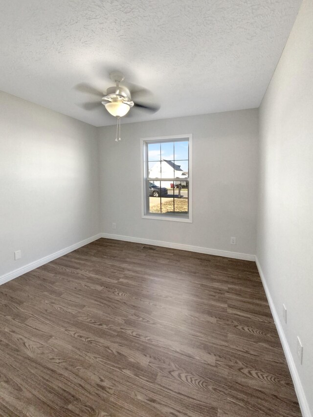 1173 Snoopy Dr, Clarksville, TN 37040 - empty room with ceiling fan, a textured ceiling, baseboards, and dark wood-type flooring