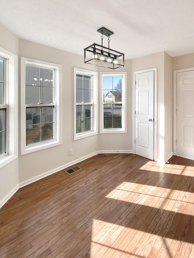 1173 Snoopy Dr, Clarksville, TN 37040 - unfurnished dining area with baseboards, visible vents, and hardwood / wood-style floors