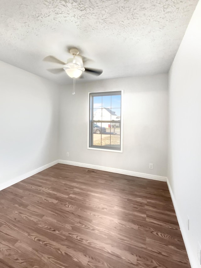 1173 Snoopy Dr, Clarksville, TN 37040 - unfurnished room with a ceiling fan, a textured ceiling, baseboards, and dark wood-type flooring
