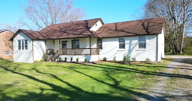 view of front of home featuring driveway, a front lawn, a porch, and stucco siding