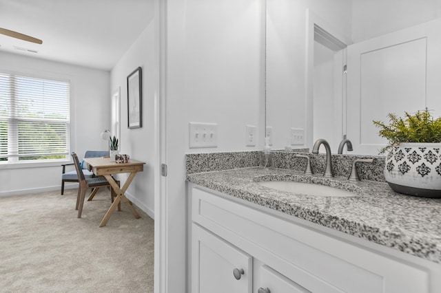 bathroom with vanity and baseboards