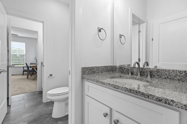 bathroom with toilet and vanity