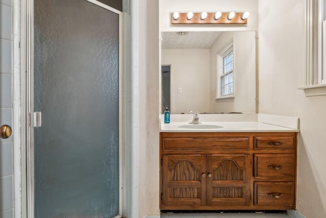 full bathroom featuring a shower stall and vanity