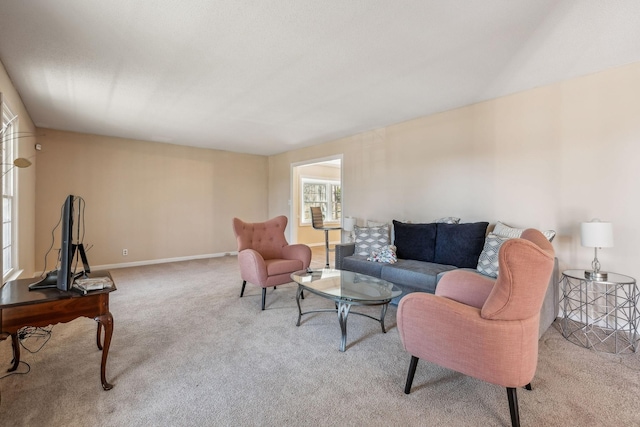 living area featuring carpet flooring and baseboards