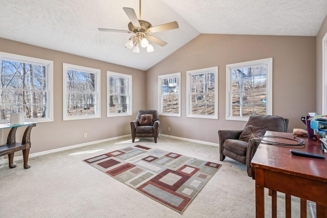 living area featuring light carpet, vaulted ceiling, and a wealth of natural light