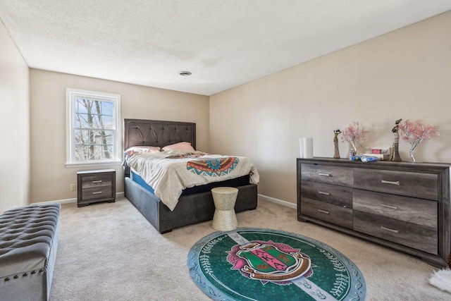 bedroom with a textured ceiling, carpet floors, and baseboards