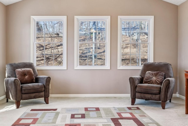 living area with lofted ceiling, carpet, and plenty of natural light