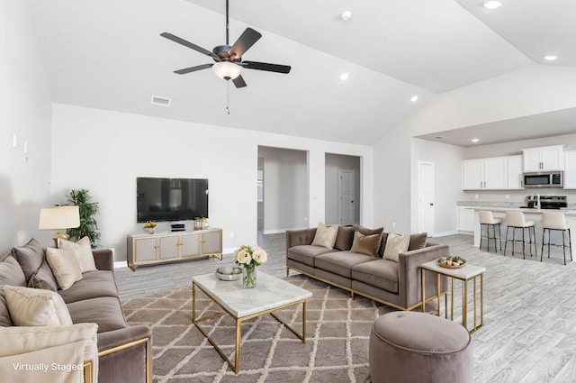 living room featuring recessed lighting, wood finished floors, visible vents, and baseboards