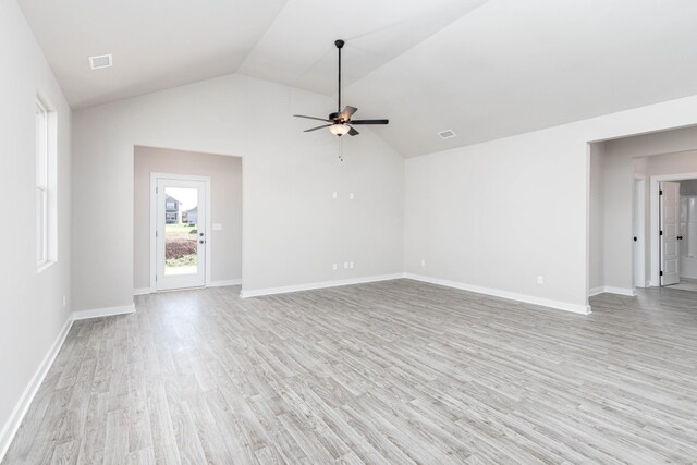 unfurnished living room featuring light wood-style floors, ceiling fan, baseboards, and vaulted ceiling