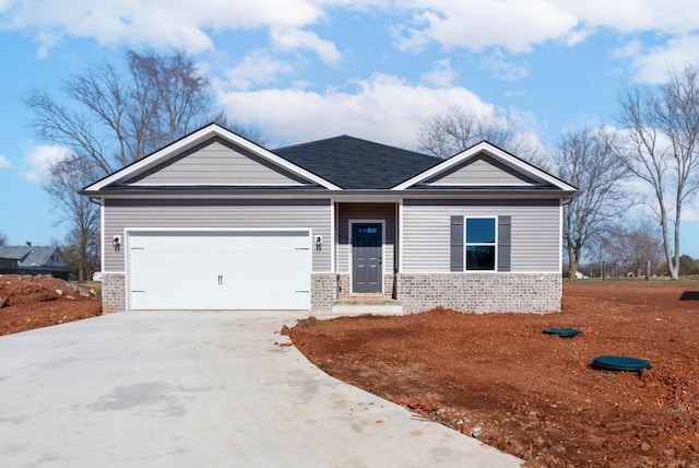 view of front of property with a garage, driveway, and brick siding