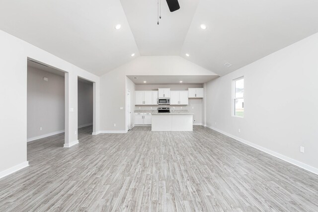 unfurnished living room featuring baseboards, a ceiling fan, light wood-style flooring, high vaulted ceiling, and recessed lighting