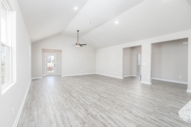 unfurnished living room with lofted ceiling, ceiling fan, light wood-style flooring, and baseboards