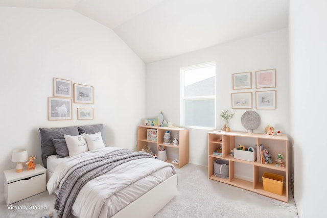 carpeted bedroom with lofted ceiling