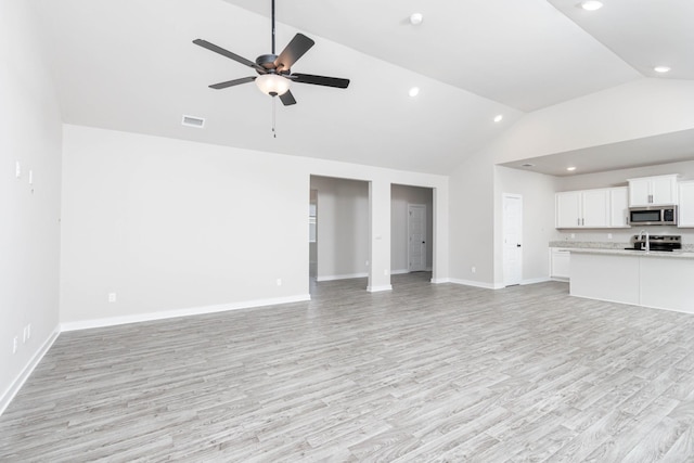 unfurnished living room with baseboards, light wood-style flooring, visible vents, and a ceiling fan