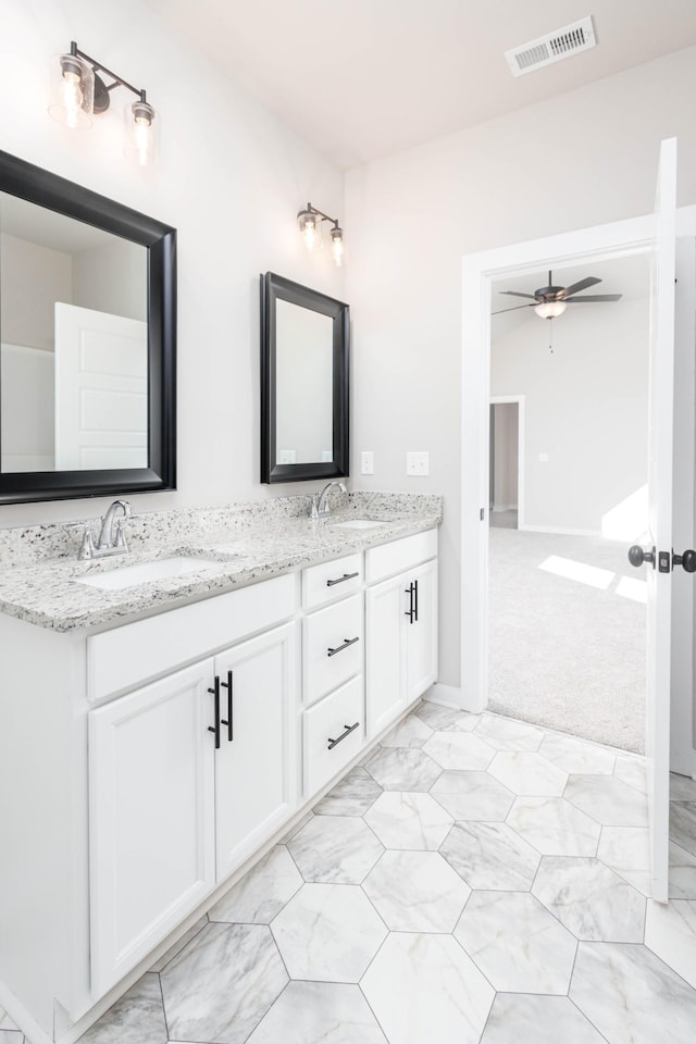 full bathroom with ceiling fan, double vanity, a sink, and visible vents