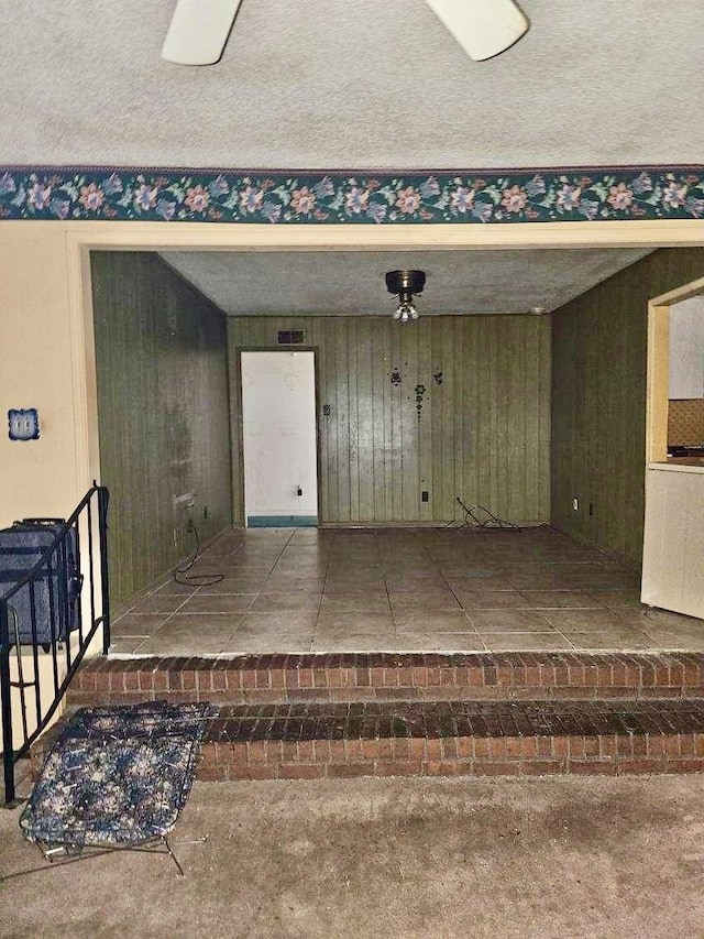 garage featuring wood walls and visible vents