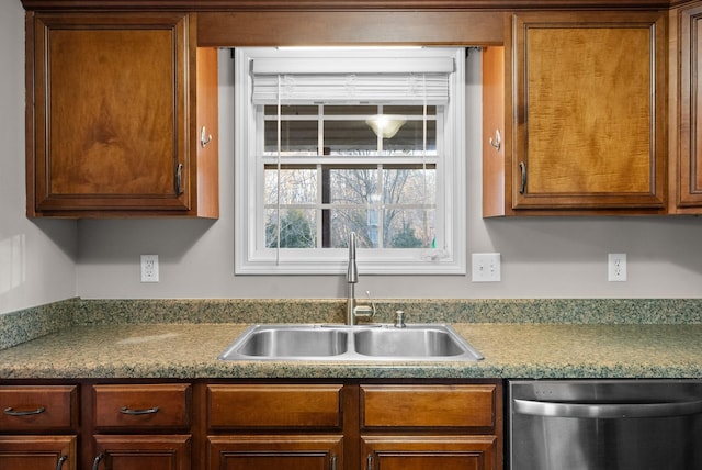 kitchen with a sink, brown cabinets, and stainless steel dishwasher