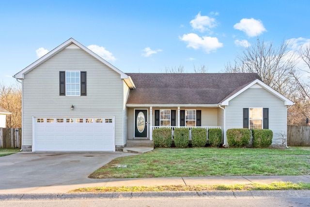 traditional-style house featuring a shingled roof, covered porch, concrete driveway, a front yard, and fence