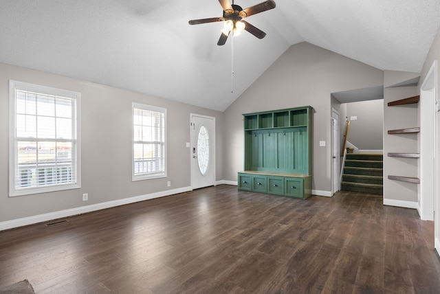 interior space featuring dark wood-style floors, stairs, visible vents, and a ceiling fan