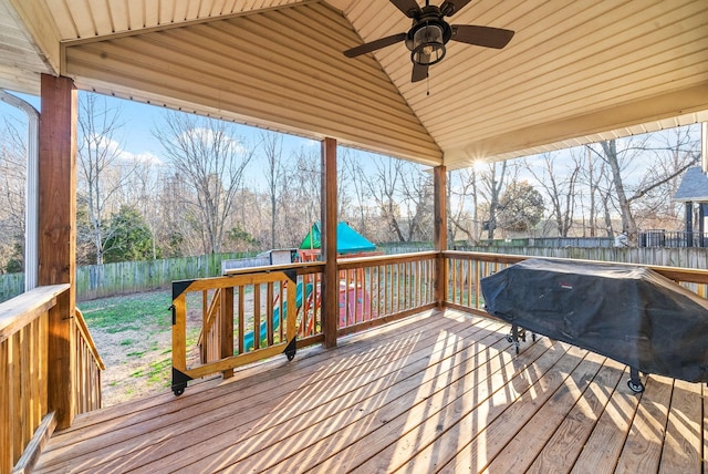 wooden deck with a ceiling fan, a fenced backyard, and a grill