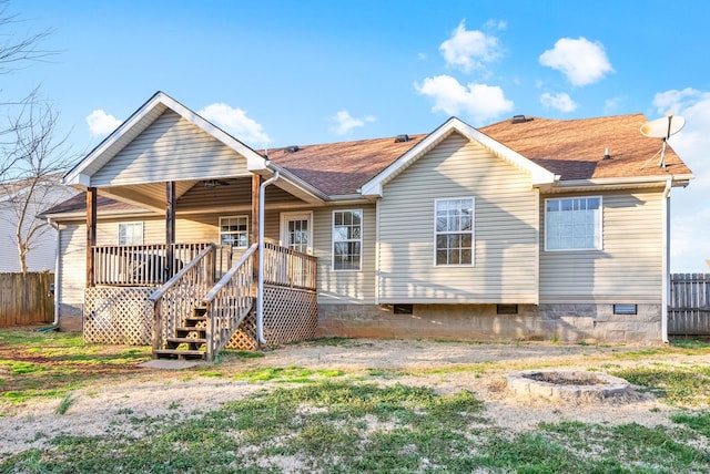 back of house featuring a shingled roof, crawl space, fence, and a wooden deck