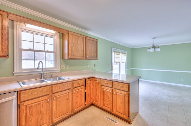 kitchen featuring light countertops, a peninsula, stainless steel dishwasher, plenty of natural light, and a sink