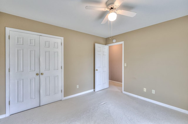 unfurnished bedroom featuring a closet, ceiling fan, baseboards, and carpet