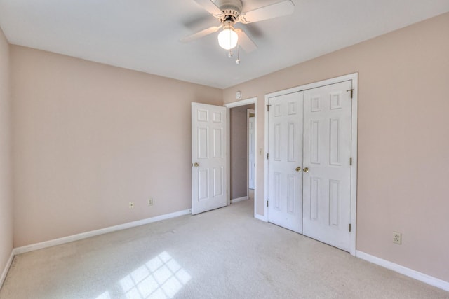 unfurnished bedroom with a ceiling fan, light colored carpet, baseboards, and a closet