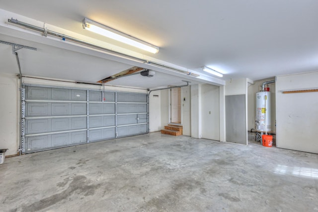 garage featuring water heater and a garage door opener