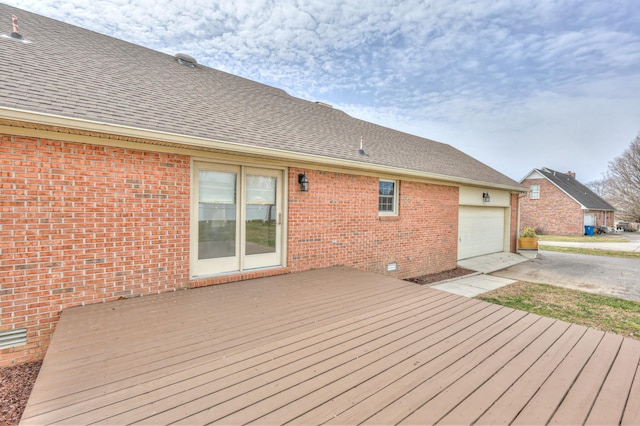 wooden deck featuring a garage