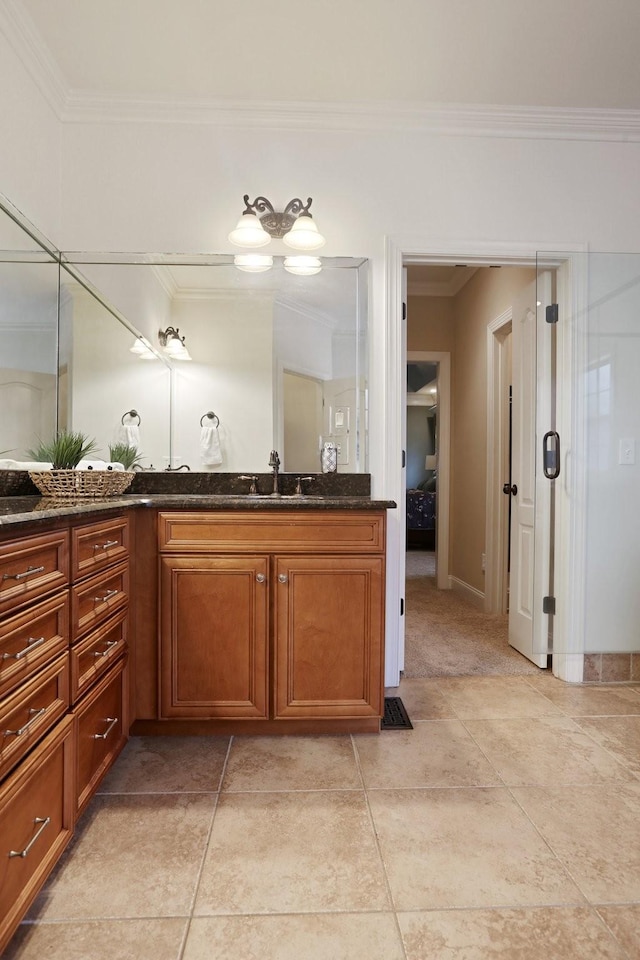 bathroom featuring tile patterned flooring, vanity, and crown molding