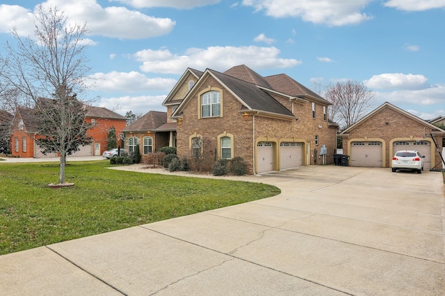 view of front of home with a garage, concrete driveway, brick siding, and a front lawn