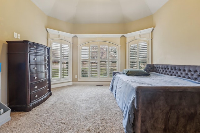 bedroom featuring lofted ceiling and carpet